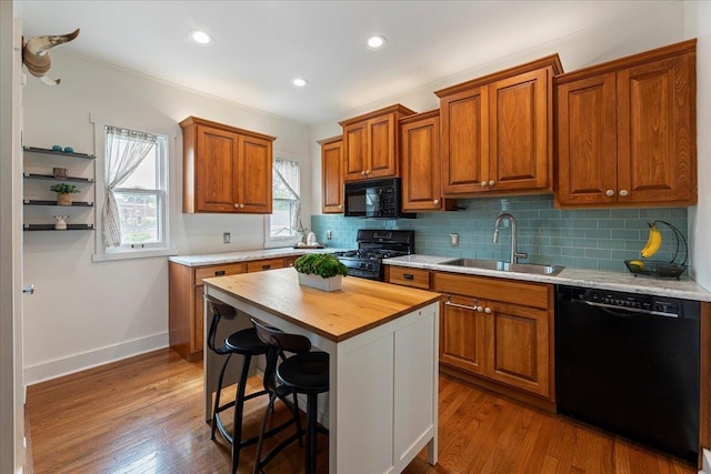 816 S 49th St, Omaha, NE 68106 - kitchen featuring black appliances, a sink, butcher block counters, tasteful backsplash, and recessed lighting