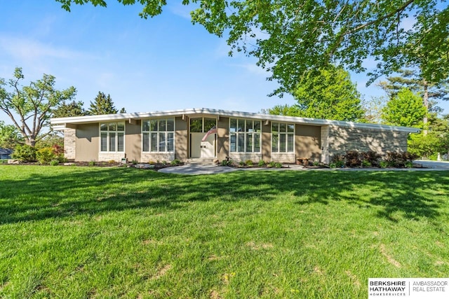 6426 Country Squire Ln, Omaha, NE 68152 - mid-century inspired home with stone siding and a front lawn