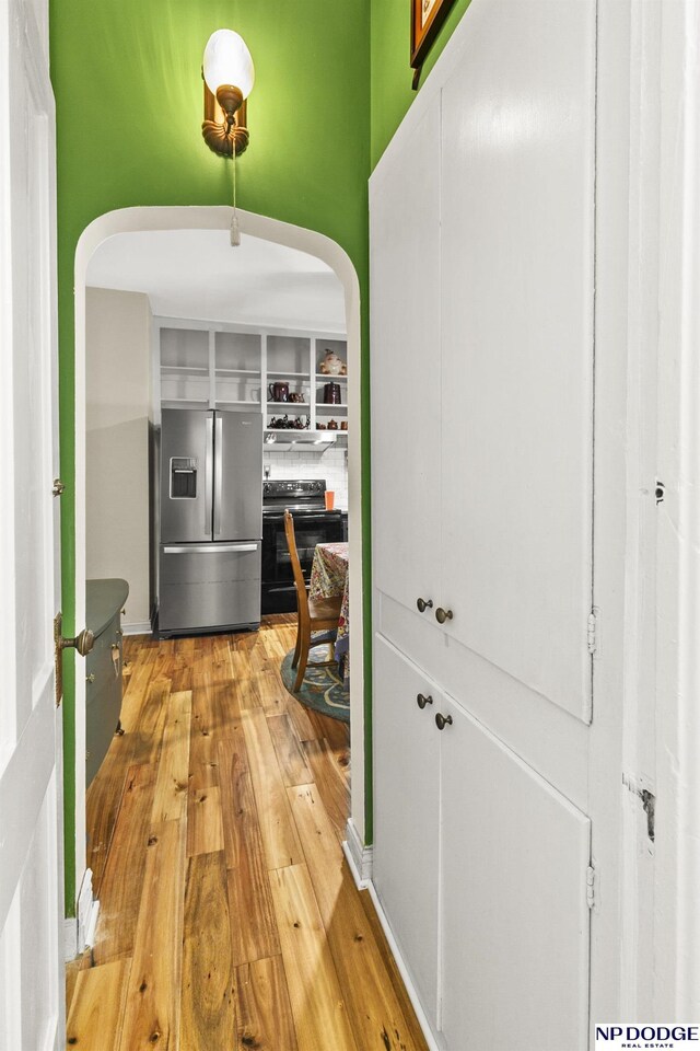 15410 Bennington Rd, Bennington, NE 68007 - corridor with arched walkways and light wood finished floors