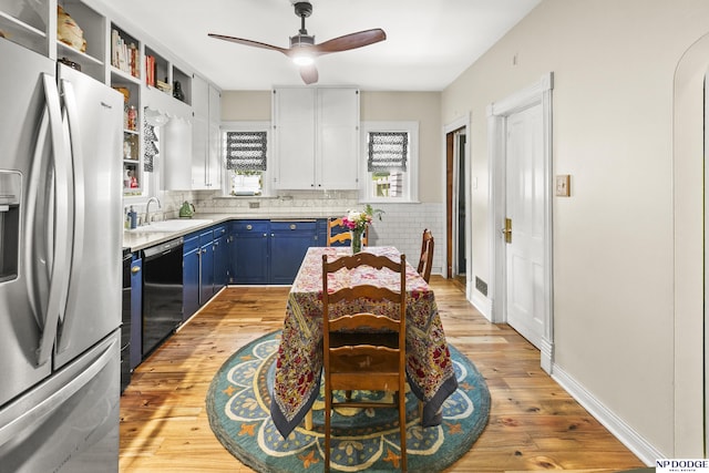 15410 Bennington Rd, Bennington, NE 68007 - kitchen featuring stainless steel appliances, blue cabinetry, a ceiling fan, light countertops, and white cabinetry