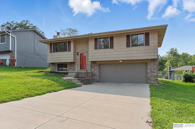 13304 S 21st St, Bellevue, NE 68123 - raised ranch featuring an attached garage, concrete driveway, and a chimney