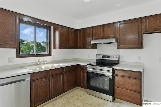 13304 S 21st St, Bellevue, NE 68123 - kitchen with appliances with stainless steel finishes, under cabinet range hood, and light countertops