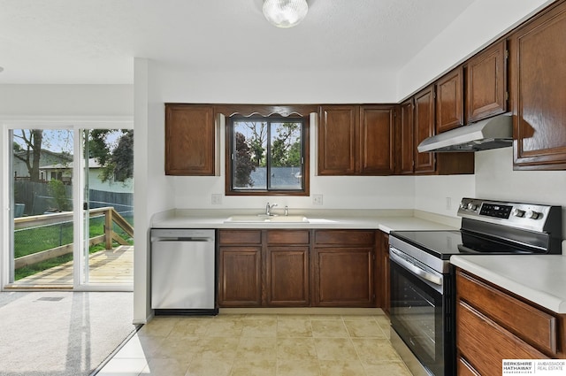 13304 S 21st St, Bellevue, NE 68123 - kitchen with appliances with stainless steel finishes, under cabinet range hood, light countertops, and light tile patterned flooring