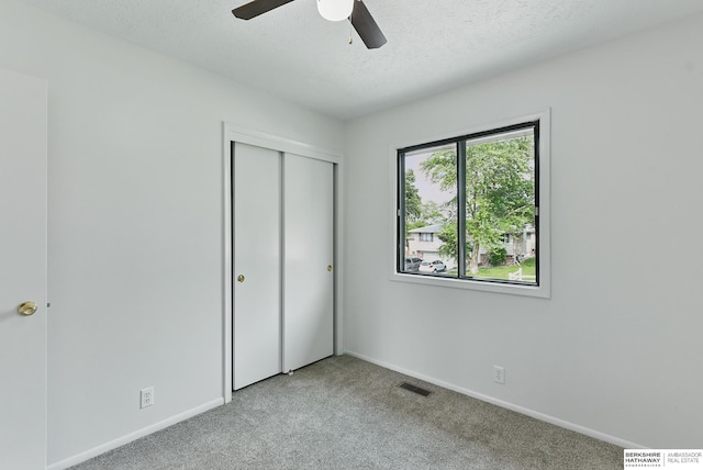 13304 S 21st St, Bellevue, NE 68123 - unfurnished bedroom with carpet floors, a closet, a textured ceiling, and ceiling fan