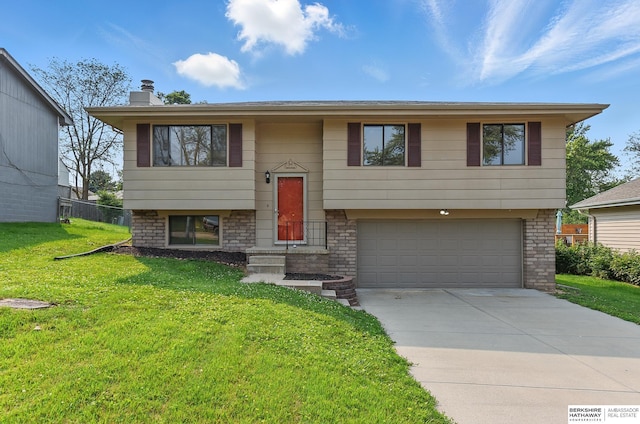 13304 S 21st St, Bellevue, NE 68123 - bi-level home featuring an attached garage, a front yard, driveway, and a chimney