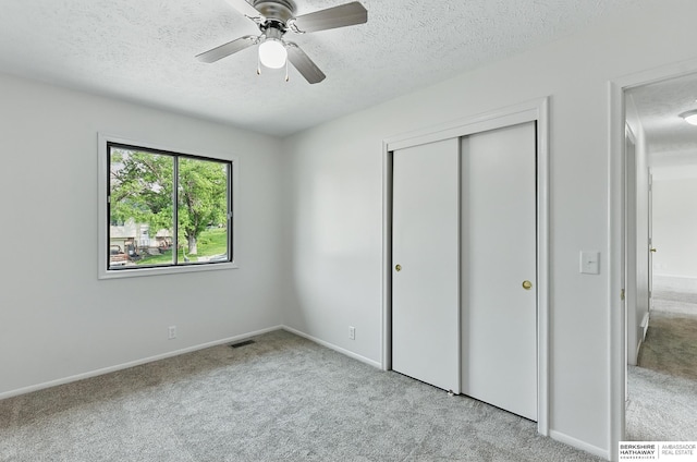 13304 S 21st St, Bellevue, NE 68123 - unfurnished bedroom featuring a textured ceiling, carpet flooring, a closet, and a ceiling fan