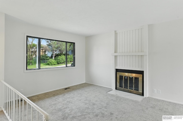 13304 S 21st St, Bellevue, NE 68123 - unfurnished living room featuring a fireplace and carpet