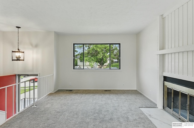 13304 S 21st St, Bellevue, NE 68123 - unfurnished living room with a chandelier, carpet flooring, and a large fireplace