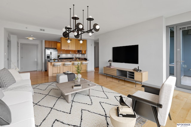 3200 Farnam Ct Unit 3604, Omaha, NE 68131 - living area featuring light wood-style flooring and a chandelier