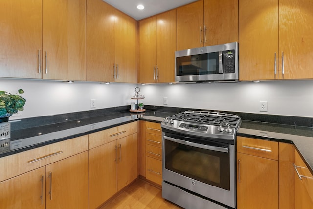 3200 Farnam Ct Unit 3604, Omaha, NE 68131 - kitchen featuring stainless steel appliances, light wood-type flooring, dark stone counters, and recessed lighting