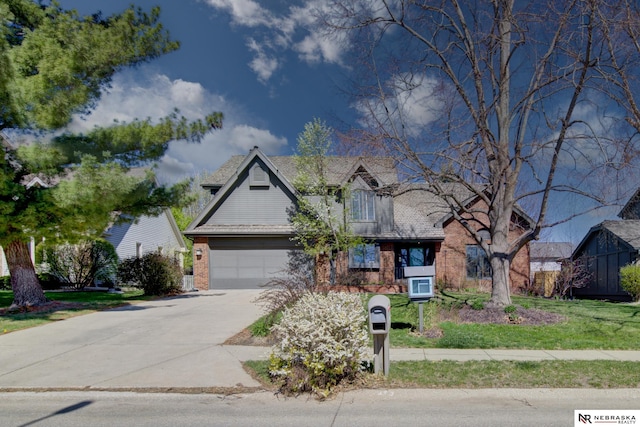 716 N 148th St, Omaha, NE 68154 - view of front of house with concrete driveway, brick siding, and an attached garage