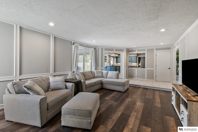716 N 148th St, Omaha, NE 68154 - living room with a decorative wall, dark wood-type flooring, a textured ceiling, recessed lighting, and crown molding