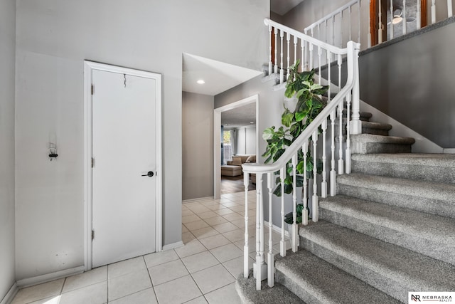 716 N 148th St, Omaha, NE 68154 - stairway with tile patterned flooring, baseboards, a high ceiling, and recessed lighting