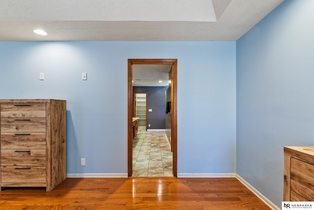 716 N 148th St, Omaha, NE 68154 - empty room featuring wood finished floors, baseboards, a textured ceiling, and recessed lighting
