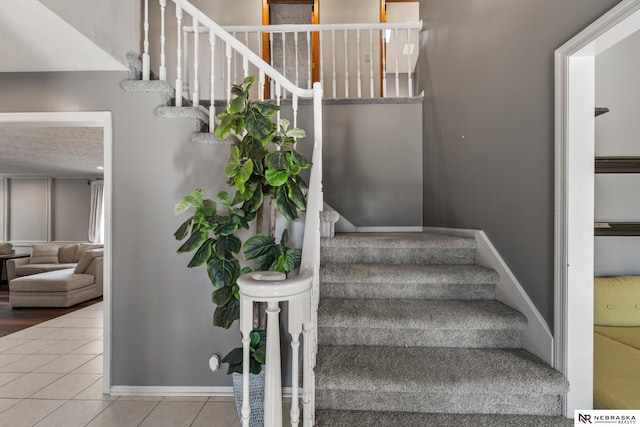 716 N 148th St, Omaha, NE 68154 - stairs featuring tile patterned floors and baseboards