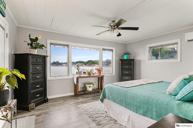 112 W Lakeshore Dr, Lincoln, NE 68528 - bedroom featuring multiple windows, light wood-style flooring, ornamental molding, a ceiling fan, and baseboards