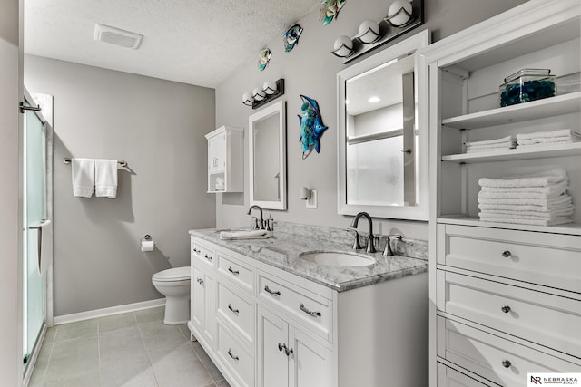 112 W Lakeshore Dr, Lincoln, NE 68528 - bathroom featuring a shower stall, double vanity, toilet, baseboards, and tile patterned flooring