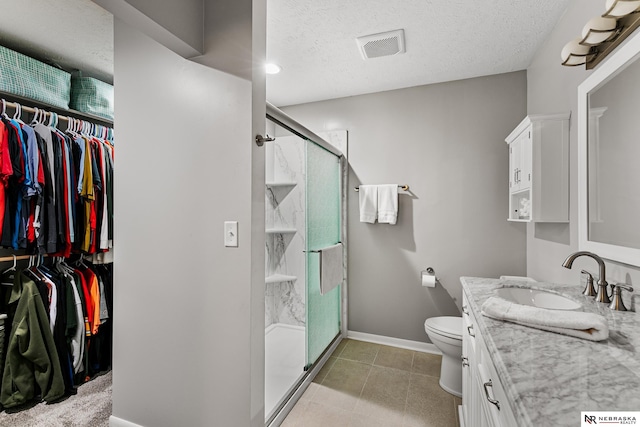112 W Lakeshore Dr, Lincoln, NE 68528 - bathroom with vanity, baseboards, a shower stall, a textured ceiling, and toilet