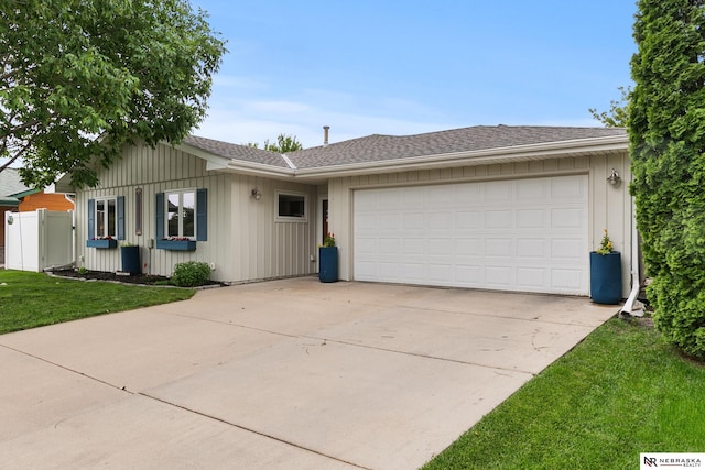 112 W Lakeshore Dr, Lincoln, NE 68528 - ranch-style house featuring driveway, a garage, a front lawn, and roof with shingles
