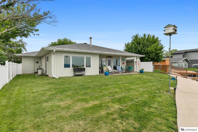 112 W Lakeshore Dr, Lincoln, NE 68528 - rear view of house featuring board and batten siding, a patio, and a shingled roof