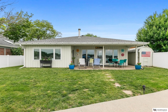 112 W Lakeshore Dr, Lincoln, NE 68528 - back of house with board and batten siding, a patio area, and roof with shingles