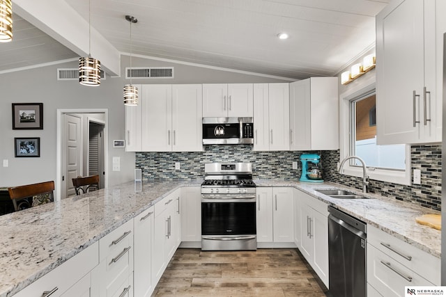 112 W Lakeshore Dr, Lincoln, NE 68528 - kitchen featuring stainless steel appliances, a sink, light wood-type flooring, white cabinetry, and tasteful backsplash