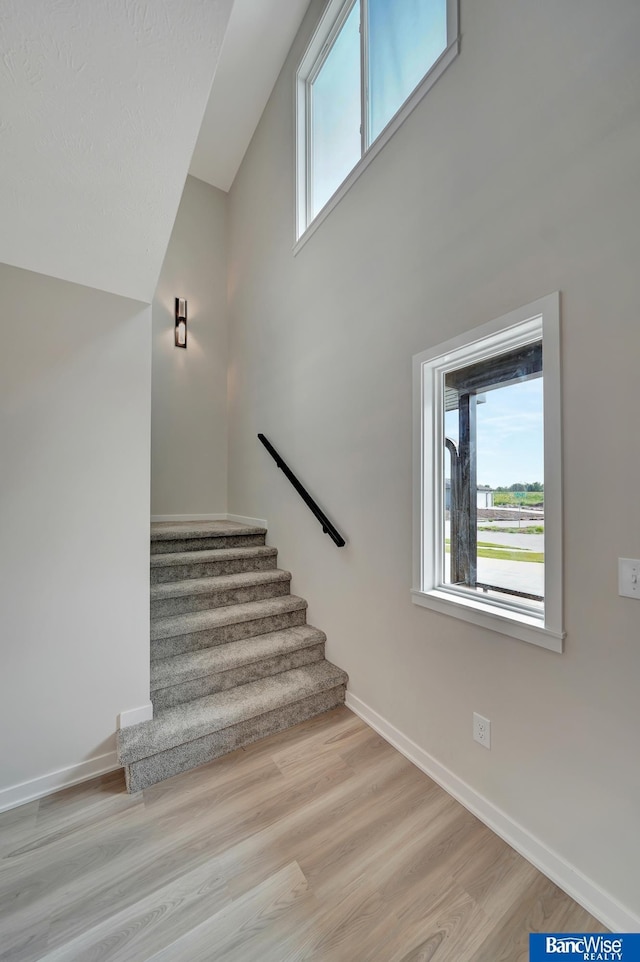 3556 Pearl Crescent Dr, Lincoln, NE 68504 - stairway with baseboards, wood finished floors, and a high ceiling