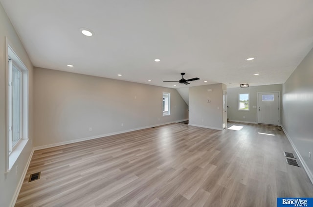 3556 Pearl Crescent Dr, Lincoln, NE 68504 - unfurnished living room featuring healthy amount of natural light, baseboards, recessed lighting, light wood-style flooring, and ceiling fan