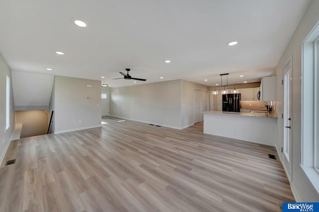 3556 Pearl Crescent Dr, Lincoln, NE 68504 - unfurnished living room with recessed lighting, a sink, baseboards, a ceiling fan, and light wood-type flooring
