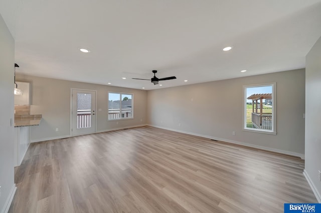 3556 Pearl Crescent Dr, Lincoln, NE 68504 - unfurnished living room with a ceiling fan, baseboards, light wood-type flooring, and recessed lighting
