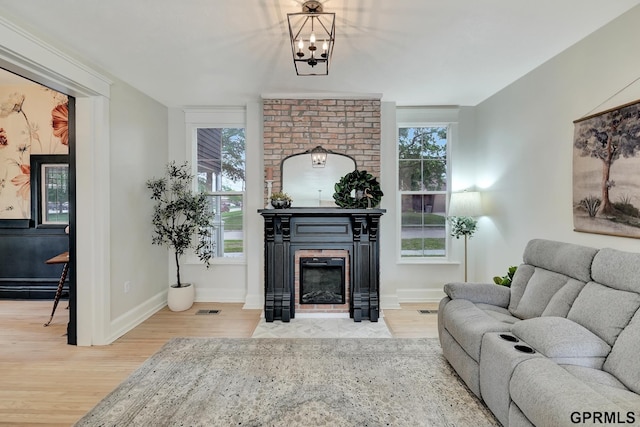 149 N 1st St, Seward, NE 68434 - living room featuring wood finished floors, a brick fireplace, and healthy amount of natural light