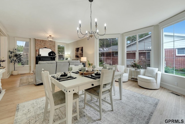 149 N 1st St, Seward, NE 68434 - dining area featuring a chandelier, light wood-style flooring, and baseboards