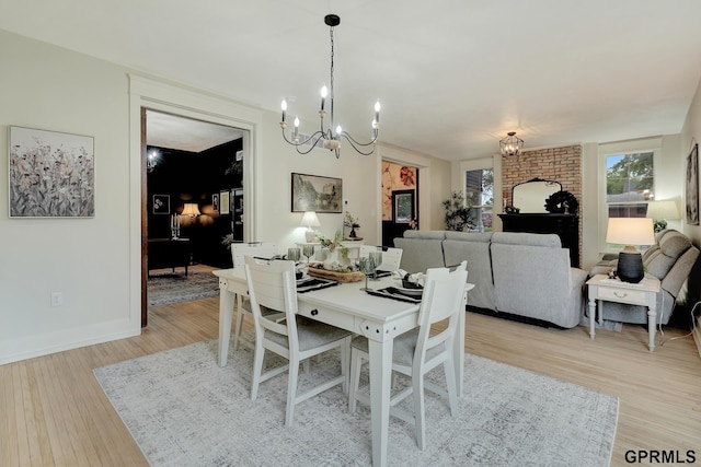 149 N 1st St, Seward, NE 68434 - dining room with a chandelier, light wood-style floors, and baseboards