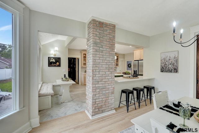 149 N 1st St, Seward, NE 68434 - kitchen with ornate columns, stainless steel fridge with ice dispenser, a kitchen breakfast bar, and plenty of natural light