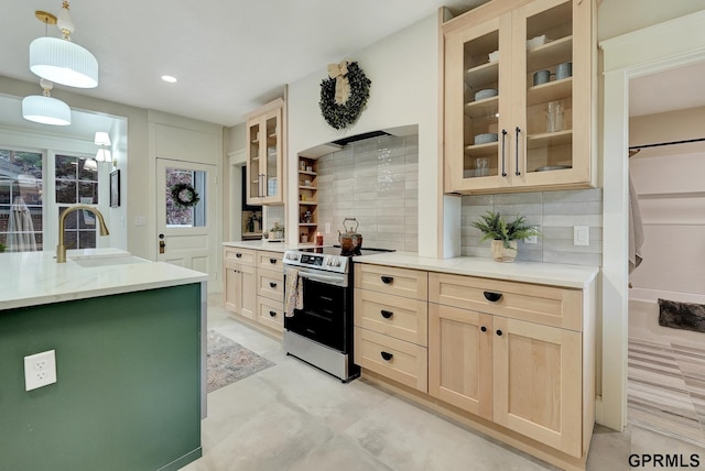 149 N 1st St, Seward, NE 68434 - kitchen with electric stove, a sink, decorative backsplash, pendant lighting, and recessed lighting