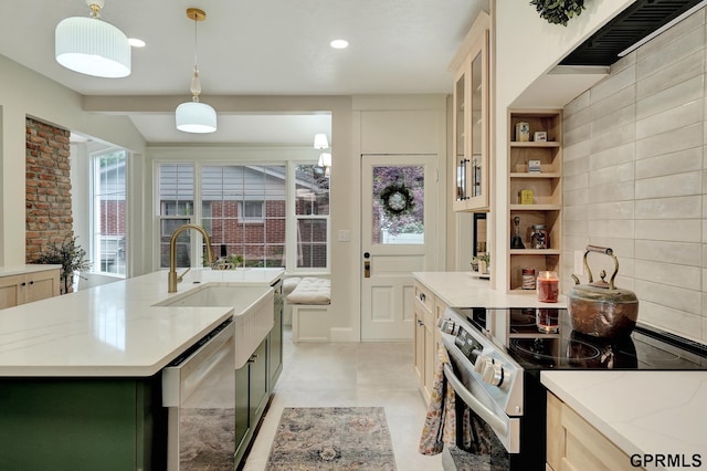 149 N 1st St, Seward, NE 68434 - kitchen with stainless steel appliances, a sink, light stone countertops, decorative light fixtures, and a kitchen island with sink