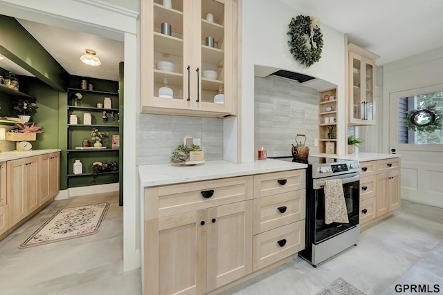 149 N 1st St, Seward, NE 68434 - kitchen with electric range, tasteful backsplash, glass insert cabinets, light stone counters, and open shelves
