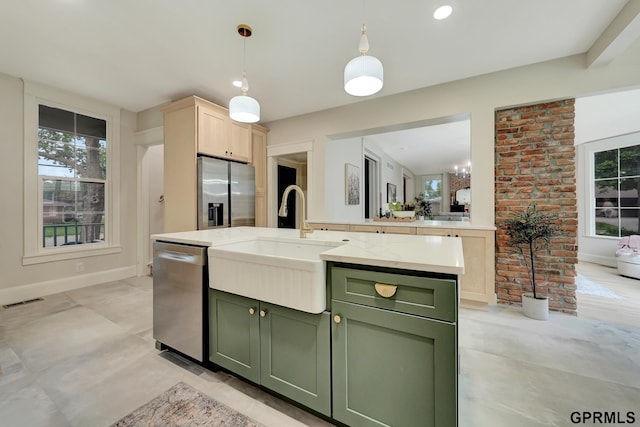 149 N 1st St, Seward, NE 68434 - kitchen featuring green cabinetry, stainless steel appliances, a sink, baseboards, and decorative light fixtures