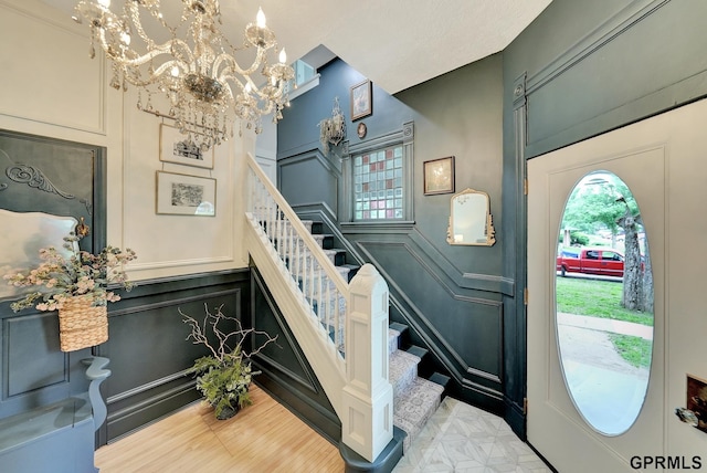 149 N 1st St, Seward, NE 68434 - entrance foyer with a decorative wall, stairway, a chandelier, and wood finished floors