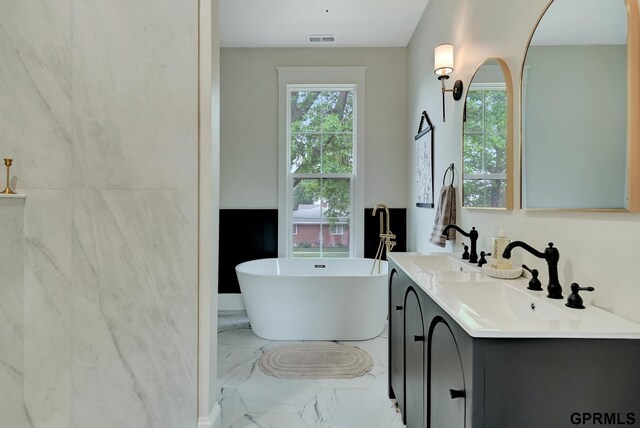 149 N 1st St, Seward, NE 68434 - bathroom with marble finish floors, double vanity, and a soaking tub
