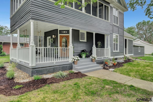 149 N 1st St, Seward, NE 68434 - view of front of house featuring a porch and a front lawn