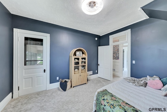 149 N 1st St, Seward, NE 68434 - carpeted bedroom featuring a textured ceiling and baseboards