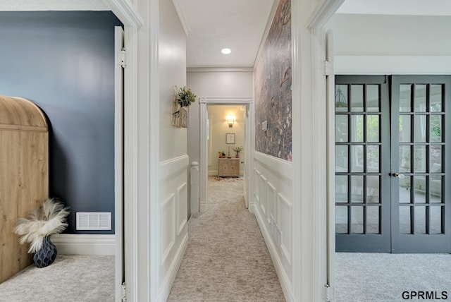 149 N 1st St, Seward, NE 68434 - hall with carpet floors, a decorative wall, french doors, and a wainscoted wall