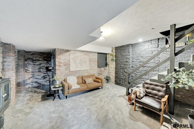 149 N 1st St, Seward, NE 68434 - carpeted living area featuring stairs and brick wall