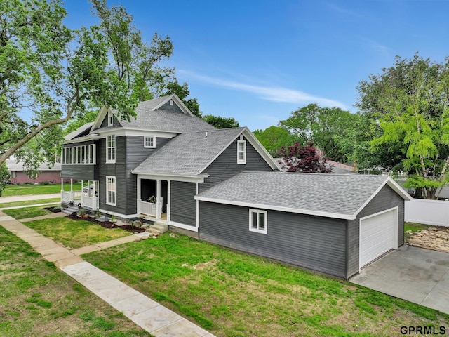 149 N 1st St, Seward, NE 68434 - view of front of house with roof with shingles, a front yard, and a garage