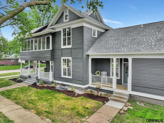 149 N 1st St, Seward, NE 68434 - view of front of home featuring covered porch, a shingled roof, and a front lawn