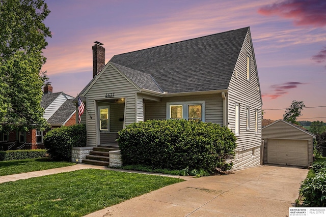4427 Pine St, Omaha, NE 68105 - view of front of house with an outdoor structure, roof with shingles, a detached garage, a yard, and a chimney