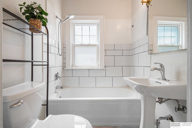 4427 Pine St, Omaha, NE 68105 - bathroom featuring toilet, plenty of natural light, and washtub / shower combination