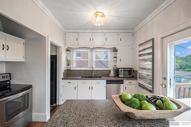 4427 Pine St, Omaha, NE 68105 - kitchen featuring stainless steel appliances, a sink, ornamental molding, white cabinetry, and open shelves