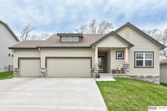 8622 N 177th St, Bennington, NE 68007 - craftsman inspired home with an attached garage, driveway, stone siding, a front lawn, and a shingled roof